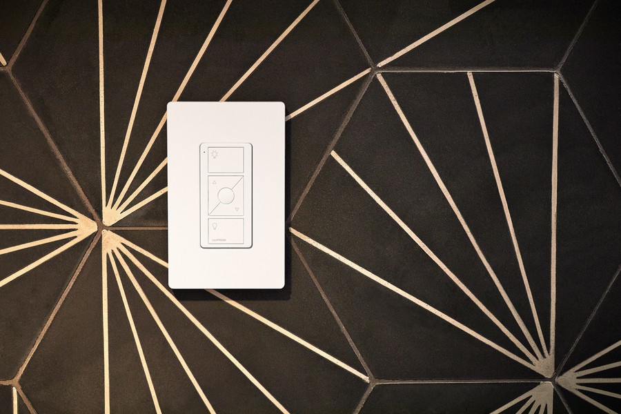 A Lutron smart switch against a designer wallpaper. 