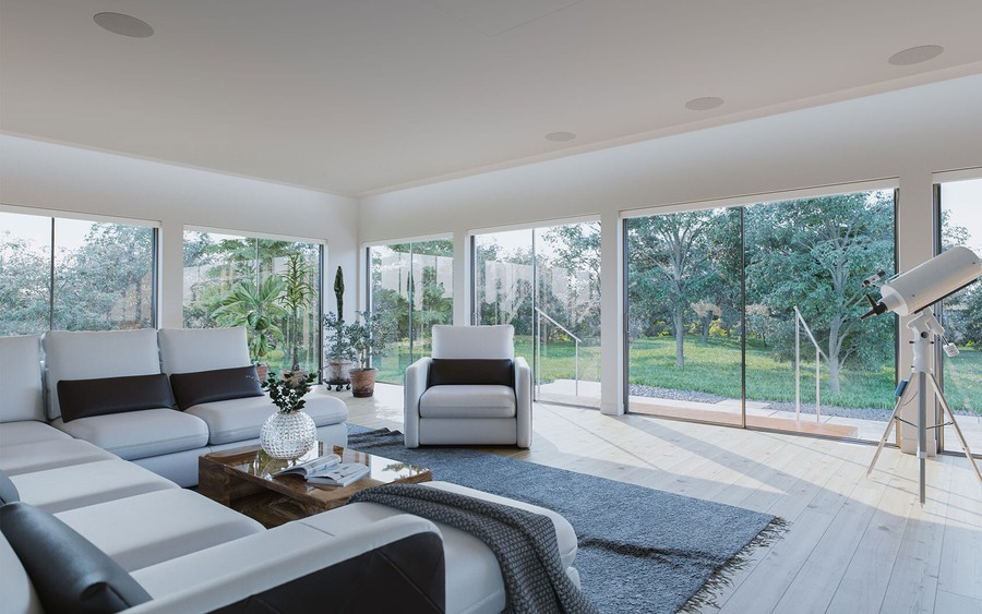 A modern, light-filled living area with multiple windows and glass doors.