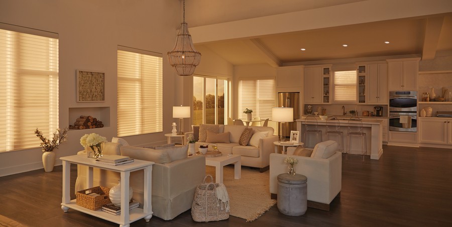A view of a sophisticated living area with motorized shades filtering the sun in a luxury home.